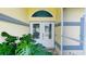 Bright double front door with decorative windows and transom window to let in the light at 2399 Bendway Dr, Port Charlotte, FL 33948