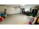 Spacious garage with a white door, gray floor, and ample storage at 2399 Bendway Dr, Port Charlotte, FL 33948