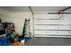 Garage with white door, ladder, and gray floor at 2399 Bendway Dr, Port Charlotte, FL 33948