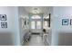 Bright and inviting entrance hall with views to the front door and charming decorative accents at 2399 Bendway Dr, Port Charlotte, FL 33948