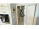 Hallway view featuring white cabinets, stainless oven, and decorative wall art at 2399 Bendway Dr, Port Charlotte, FL 33948