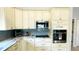 Well-lit kitchen with white cabinets, stainless steel appliances, and stone countertops at 2399 Bendway Dr, Port Charlotte, FL 33948