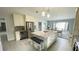 Bright kitchen featuring an island with bar seating, stainless appliances, and ample counter space at 2399 Bendway Dr, Port Charlotte, FL 33948