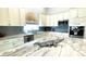 Modern kitchen boasts granite countertops, custom cabinets, and stainless steel appliances at 2399 Bendway Dr, Port Charlotte, FL 33948