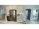 Kitchen featuring stainless steel refrigerator, white cabinets and view to the outside at 2399 Bendway Dr, Port Charlotte, FL 33948