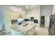 Updated kitchen with white cabinetry, an island, stainless appliances, and modern finishes at 2399 Bendway Dr, Port Charlotte, FL 33948