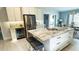 Spacious kitchen island with marble countertop, seating, stainless refrigerator, and beverage cooler at 2399 Bendway Dr, Port Charlotte, FL 33948