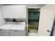 Laundry room with modern appliances offering garage access and ample storage space at 2399 Bendway Dr, Port Charlotte, FL 33948