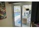 Bright living room featuring pool views and access to adjacent covered patio at 2399 Bendway Dr, Port Charlotte, FL 33948