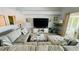 Relaxing living room with a large sectional sofa and view of the outdoor lanai and pool at 2399 Bendway Dr, Port Charlotte, FL 33948