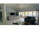 Comfortable living room with large TV, modern lighting, and sliding glass doors to outdoor living space at 2399 Bendway Dr, Port Charlotte, FL 33948