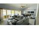 Spacious living room with comfortable seating and sliding glass doors to the pool area at 2399 Bendway Dr, Port Charlotte, FL 33948