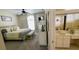 Bedroom with a neutral palette, a bed with decorative pillows, and an adjacent bathroom at 2399 Bendway Dr, Port Charlotte, FL 33948