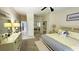 Bright main bedroom boasts a yellow and grey color scheme, ensuite, and mirrored closet at 2399 Bendway Dr, Port Charlotte, FL 33948