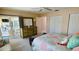 Spacious bedroom featuring a dresser and an adjacent covered patio with pool view at 2399 Bendway Dr, Port Charlotte, FL 33948