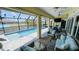Enclosed patio with pool and canal views, seating, and dining area at 2399 Bendway Dr, Port Charlotte, FL 33948