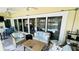 Enclosed patio with a seating area, dining table, and pool view at 2399 Bendway Dr, Port Charlotte, FL 33948