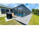 Charming backyard showcasing a screened pool enclosure with a well-maintained lawn and outdoor entertaining area at 2399 Bendway Dr, Port Charlotte, FL 33948