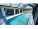 Stunning outdoor pool area with a screened enclosure, seamlessly blending indoor and outdoor living spaces for enjoyment at 2399 Bendway Dr, Port Charlotte, FL 33948
