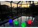 Screened in pool with color changing lights and view of the canal at sunset at 2399 Bendway Dr, Port Charlotte, FL 33948
