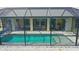Aerial view of the pool with screened-in enclosure, seamlessly blending the outdoor and indoor living spaces at 2399 Bendway Dr, Port Charlotte, FL 33948