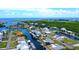 Aerial view of a waterfront home with a boat dock, surrounded by canals and lush greenery at 24239 Yacht Club Blvd, Punta Gorda, FL 33955