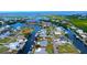 Canal-front home with private boat dock access to the bay, situated among lush landscaping and waterfront properties at 24239 Yacht Club Blvd, Punta Gorda, FL 33955