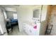 Bright bathroom featuring a modern vanity, shower with tiled walls, and an adjacent bedroom view at 24239 Yacht Club Blvd, Punta Gorda, FL 33955