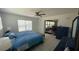 Cozy bedroom with ceiling fan, tiled floor, and view into an adjacent sunroom at 24239 Yacht Club Blvd, Punta Gorda, FL 33955