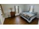 Comfortable bedroom with wood laminate flooring, dresser, and two windows at 24239 Yacht Club Blvd, Punta Gorda, FL 33955