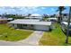 Well-maintained home with lush lawn, attached garage, metal roof, and plenty of room for RV parking at 24239 Yacht Club Blvd, Punta Gorda, FL 33955