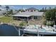 Waterfront home featuring a boat lift, screened-in lanai, and easy access to the water at 24239 Yacht Club Blvd, Punta Gorda, FL 33955
