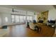 Open floor plan featuring a stone fireplace, large windows, and wood flooring at 24239 Yacht Club Blvd, Punta Gorda, FL 33955