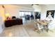 Open-concept living area with tiled floors, a view of the fireplace, and a dining area perfect for entertaining guests at 24239 Yacht Club Blvd, Punta Gorda, FL 33955