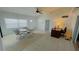 Bright living area featuring tile flooring, a ceiling fan, and ample natural light, creating a welcoming atmosphere at 24239 Yacht Club Blvd, Punta Gorda, FL 33955