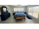 Bright main bedroom with tile floors, ceiling fan, and plantation shutters at 24239 Yacht Club Blvd, Punta Gorda, FL 33955
