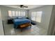 Serene bedroom featuring neutral colors, tile floors, and plantation shutters at 24239 Yacht Club Blvd, Punta Gorda, FL 33955