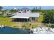 Spacious screened-in porch, ideal for outdoor dining and relaxing, overlooking the tranquil backyard and canal at 24239 Yacht Club Blvd, Punta Gorda, FL 33955