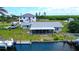 View of rear exterior with a screened porch, boat lift, and canal access at 24239 Yacht Club Blvd, Punta Gorda, FL 33955