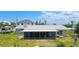 Back of the property features a screened-in porch overlooking the backyard, as well as a boat lift on the canal at 24239 Yacht Club Blvd, Punta Gorda, FL 33955