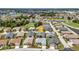 An aerial view highlights the home's location in a neighborhood surrounded by manicured landscaping at 24358 Folkstone Ave, Punta Gorda, FL 33980