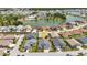 An aerial view showcases the homes location near a lake and other beautiful landscaped properties at 24358 Folkstone Ave, Punta Gorda, FL 33980
