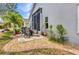 Well-manicured backyard featuring a patio with outdoor seating, lush landscaping, and serene setting at 24358 Folkstone Ave, Punta Gorda, FL 33980