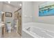 Primary bathroom with shower and soaking tub at 24358 Folkstone Ave, Punta Gorda, FL 33980