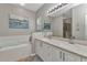 Primary bathroom featuring double sinks and a separate soaking tub at 24358 Folkstone Ave, Punta Gorda, FL 33980
