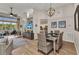 Bright living room with dining area, stylish furniture, and view to the lanai at 24358 Folkstone Ave, Punta Gorda, FL 33980