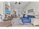 Spacious living room with vaulted ceilings and hardwood floors flowing to the dining area at 24358 Folkstone Ave, Punta Gorda, FL 33980
