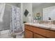 Bathroom showcasing a stylish vanity with marble countertops, bathtub, and decorative shower curtain at 25008 Lalique Pl, Punta Gorda, FL 33950