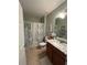 Well-maintained bathroom with a shower-tub combo, granite countertops, and ample lighting at 25008 Lalique Pl, Punta Gorda, FL 33950