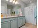 Chic bathroom with double vanity, stylish fixtures, and a patterned shower curtain adding a touch of elegance at 25008 Lalique Pl, Punta Gorda, FL 33950